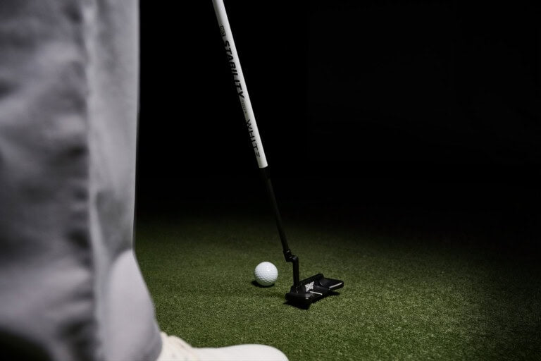Golfer using the white BGT Stability Tour putter shaft
